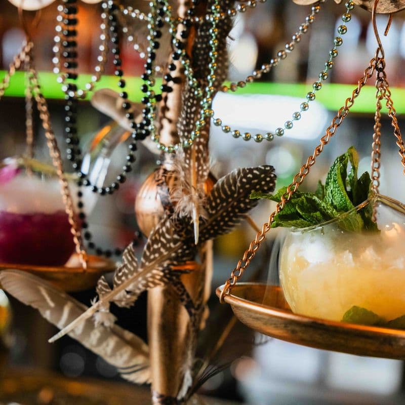 Cocktails served on hanging brass scales