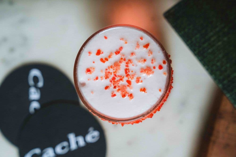 A cocktail on a Caché coaster